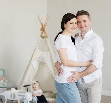 A joyful family with a toddler in a cozy room with playful decor and a teepee.